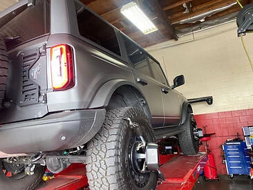 Ford Bronco on alignment rack for alignment service