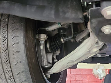 Close-up image of a vehicle's driver rear suspension