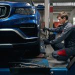Image of a mechanic setting up a car for an alignment service