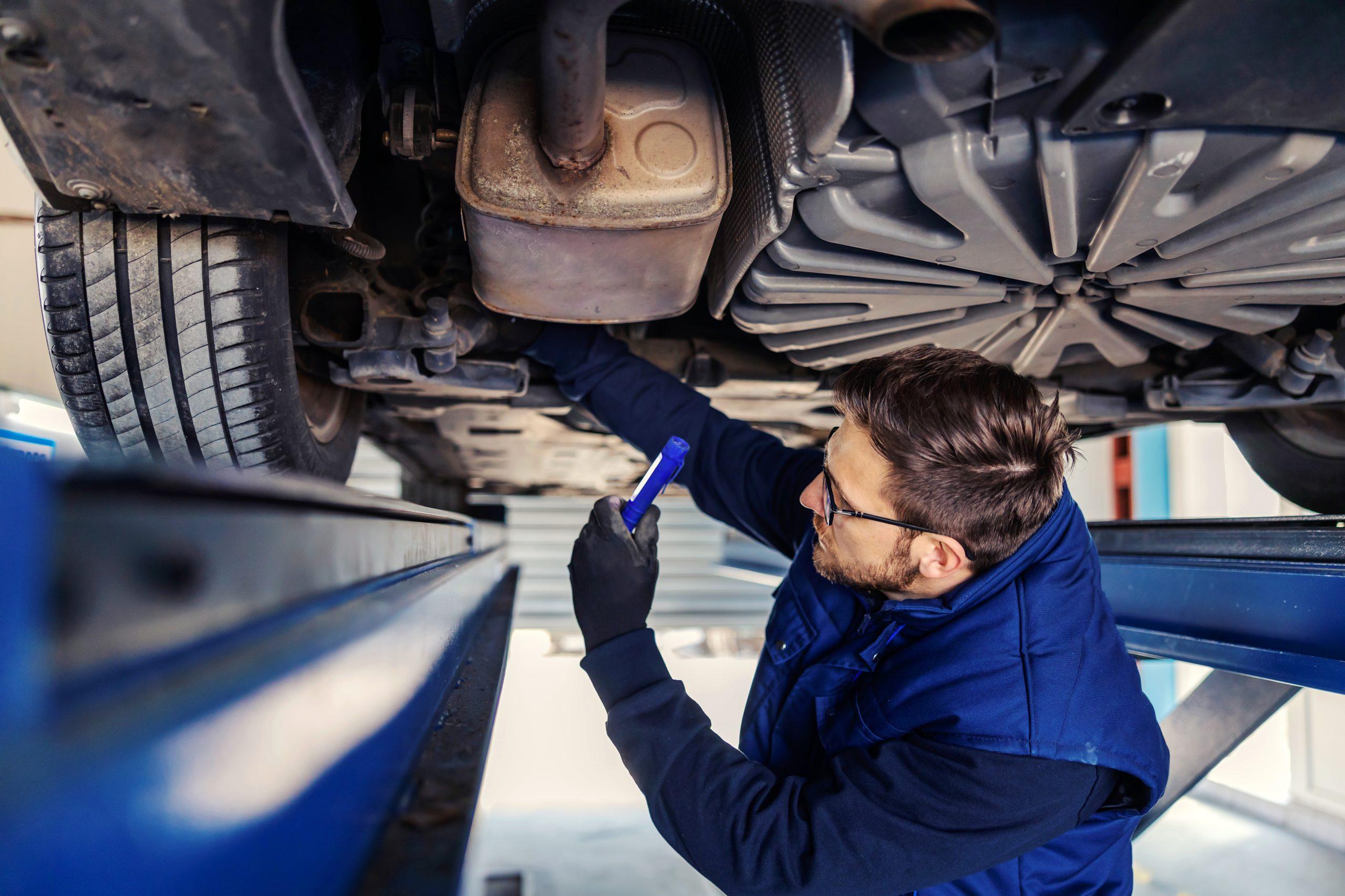 Image of a mechanic inspecting rear brakes.